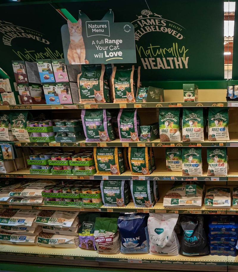 Shelf displaying various cat food brands